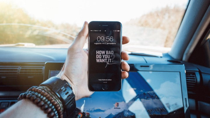 Woman looking at her phone in a car